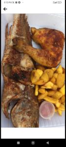 Medium sized grilled crocker fish and grilled chicken with plantain. Side.